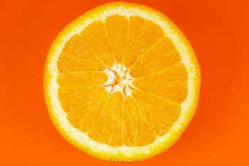 Orange fruit on orange background.  Minimalism, original beautiful photo.