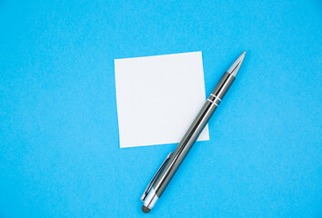 Blank white To Do List Sticker with pen. Searching information on the Internet..Close up of reminder note paper on the blue background. Copy space. Minimalism, original and creative.