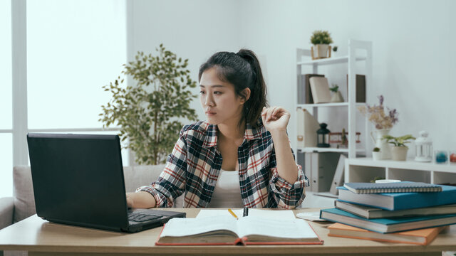 woman sitting at desk studying using pc