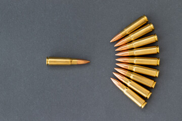 Bullets on gray paper background, one bullet in front of the others. Cartridges 7.62 caliber for...