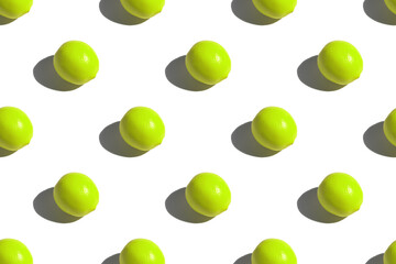 Green lemon on a white background. Lemon pattern on a white background. Hard shadows