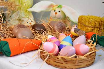 easter decoration rabbits with basket and candle eggs
