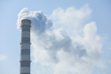 Polluting air with smoke from industrial chimney outdoors. CO2 emissions