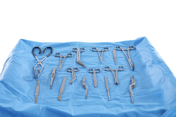 Different surgical instruments on table against light background