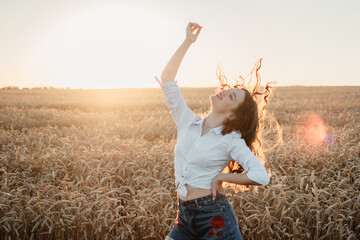 Focus on Yourself, Motivation and inspiration, rethink everything, freedom. Young brunette girl enjoying life in the sunset wheat field on summer day.