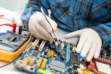 technician repairing inside of hard disk by soldering iron. Integrated Circuit. the concept of...