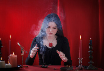 young girl in a black dress is engaged in fortune telling on  red background