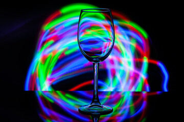 wine glass against the background of colored bright stripes