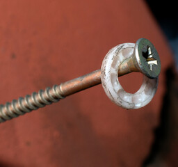 screw, with ringlets on a red-brown background