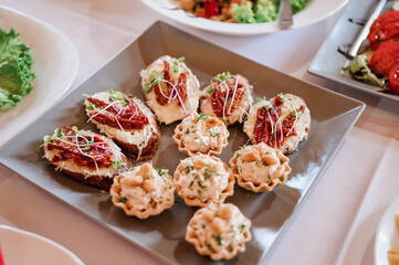 Canapes with sun-dried tomatoes and microgreen