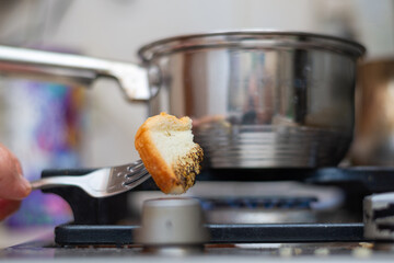 Poverty concept. Fry bread on the gas stove.