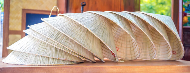 Stack of traditional Vietnamese conical leaf hats.