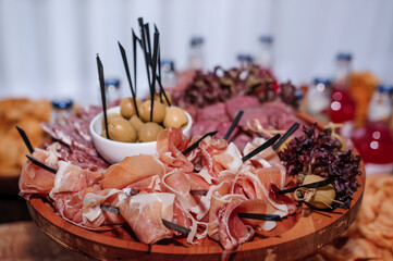 Slicing different types of meat. Wedding buffet