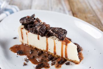 A closeup view of a slice of cookies and cream cheesecake.