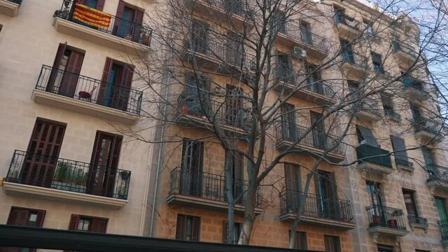 view of facades of buildings on streets of city, Catalan flags on balconies