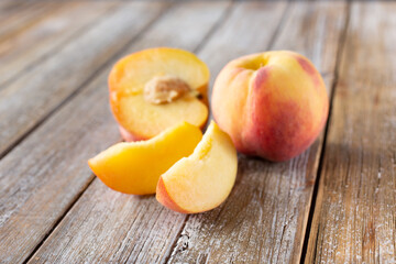 A view of peach parts in a group on a wood table surface.