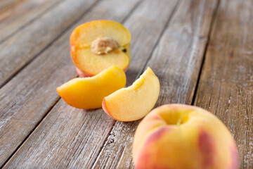 A view of peach parts scattered around a wood table surface.