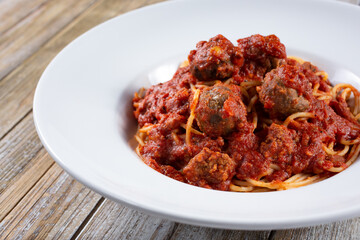 Fototapeta premium A view of a plate of spaghetti and meatballs.