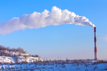 Factory plant smoke stack over blue sky background. Energy generation and air environment pollution industrial scene.