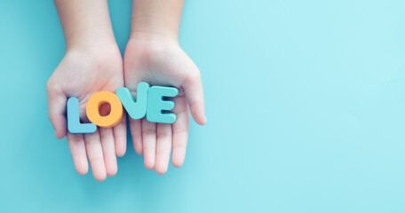 Love word on nurse hands.Caregiver to senior old elderly people.Medical health care.Nursing day.Volunteer, Kind and love.Donate and charity.Happy mother day card on blue background.Love card.Support.