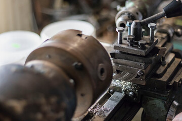 metalworking industry: working on a lathe with flying sparks. Lathe