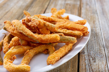A view of a plate of zucchini fries.