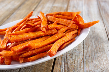 A view of a plate of sweet potato fries.