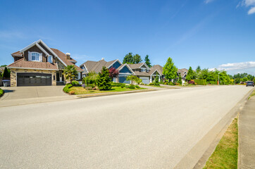 A perfect neighbourhood. Houses in suburb at Summer in the north America. Luxury houses with nice...