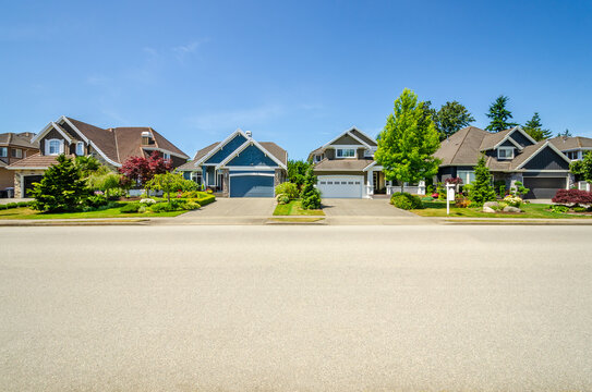 A perfect neighbourhood. Houses in suburb at Summer in the north America. Luxury houses with nice landscape.