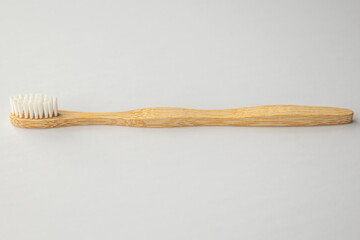 Wooden biodegradable toothbrush on white background