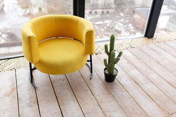 the yellow chair in the corner of a white room.