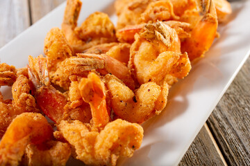 A view of a plate of deep fried shrimp.