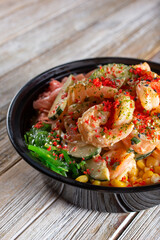 A view of a custom poke bowl, featuring shrimp.