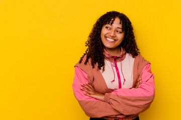 Young mixed race woman isolated on pink background smiling confident with crossed arms.