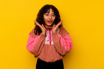 Young mixed race woman isolated on pink background surprised and shocked.