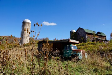 Old truck and grain silo at abandonned farm in Upstate New York