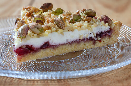 Close up of a slace of crostata with ricotta, marmalada and pistachios.