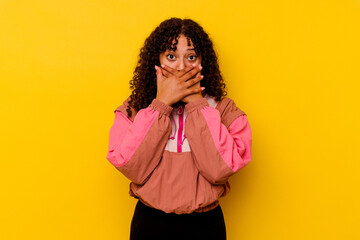 Young mixed race woman isolated on pink background shocked covering mouth with hands.