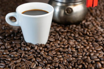 Coffee beans with american large coffee cup and moka pot.Concept Italian coffee maker background.