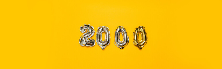 Foil number 2000 birthday balloon celebration on yellow background. Congratulation followers...