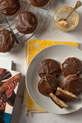 Tagalong cookies, copycat from girl scout's cookies. Made with chocolate and peanut butter on a shortbread cookie. White marble background