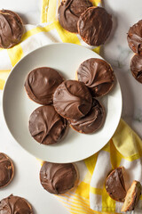 Tagalong cookies, copycat from girl scout's cookies. Made with chocolate and peanut butter on a shortbread cookie. White marble background