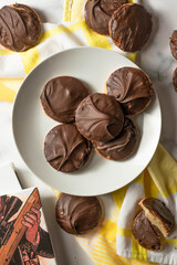Tagalong cookies, copycat from girl scout's cookies. Made with chocolate and peanut butter on a shortbread cookie. White marble background