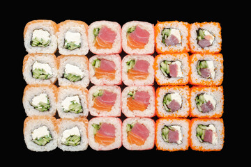 Sushi roll set with salmon, cucumber, tuna, Philadelphia cheese, masago caviar, tobiko caviar, soy paper, unagi sauce. Isolated on black background