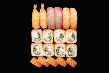 Sushi roll set with salmon, eel, Philadelphia cheese, red caviar, tobiko caviar, cucumber, chuka. Salmon nigiri, tuna nigiri, shrimp nigiri. Isolated on black background
