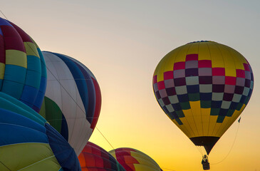 Hot air balloons against sunset sky