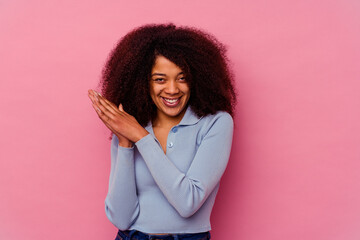 Young african american woman isolated on pink background feeling energetic and comfortable, rubbing hands confident.