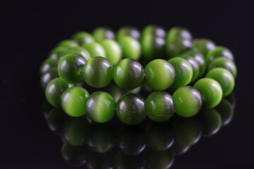 Jade necklace with a black background.