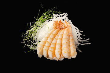tiger shrimps, daikon, microgreen. Japanese food. Isolated on black background
