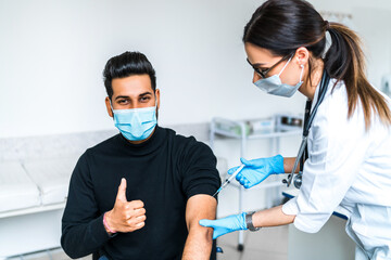 Portrait of a patient and a doctor during vaccination. Vaccination against covidus 19. Coronavirus...